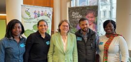 Four young Fairtrade farmers standing with Heidi Hautala, Vice President of the European Parliament
